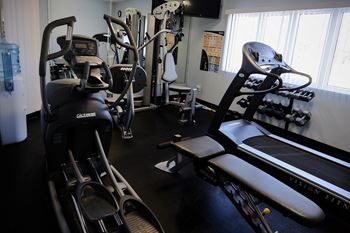 Fitness center with equipment in our clubhouse work out room